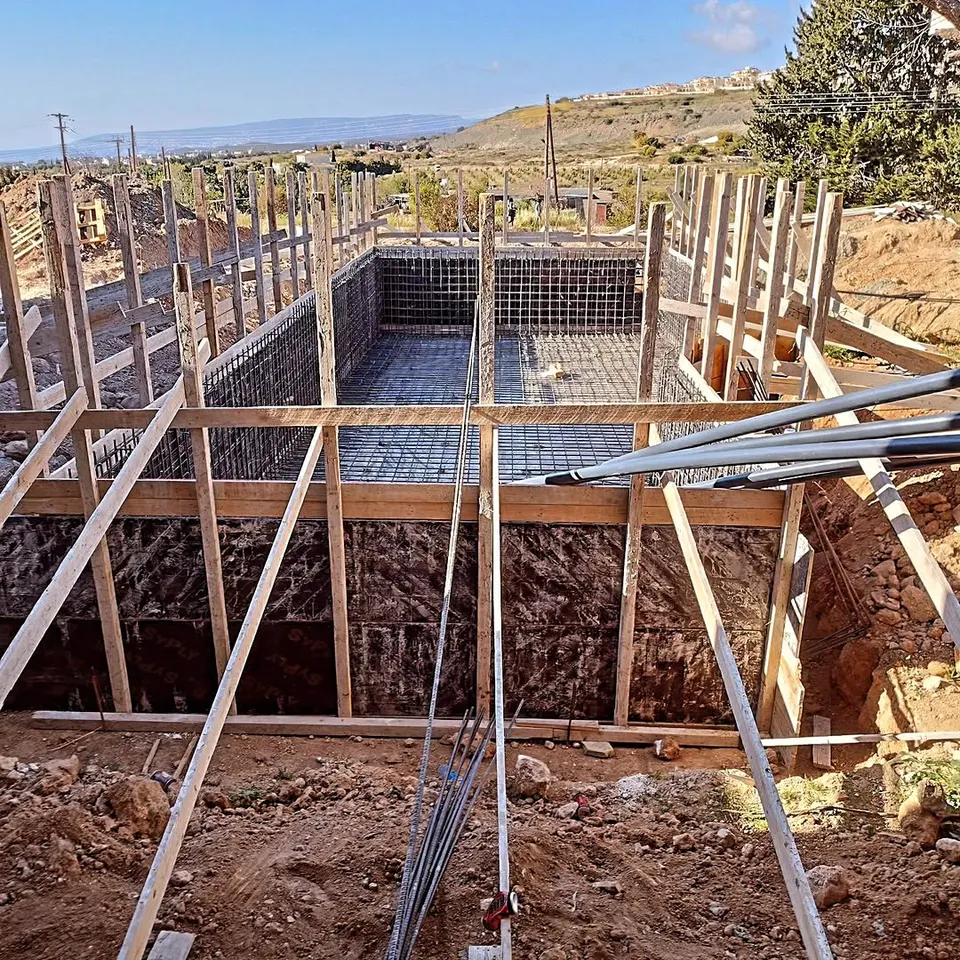 Steel reinforcement cage in a freshly dug pool pit