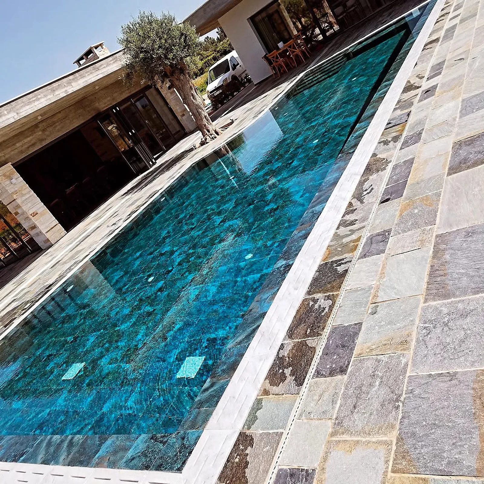 Finished pool with mosaic tiles and slate surround