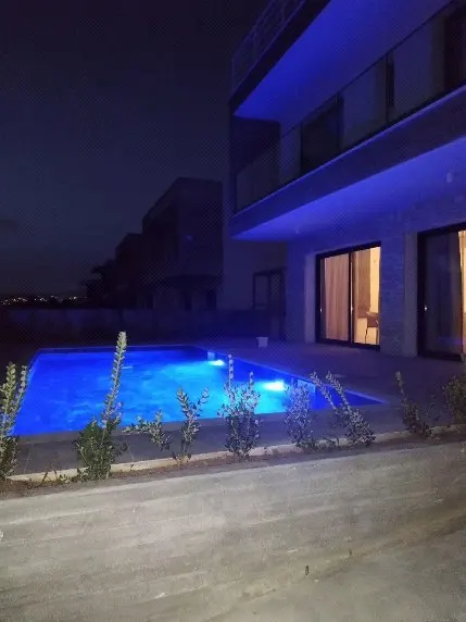 Pool with blue LED light at night